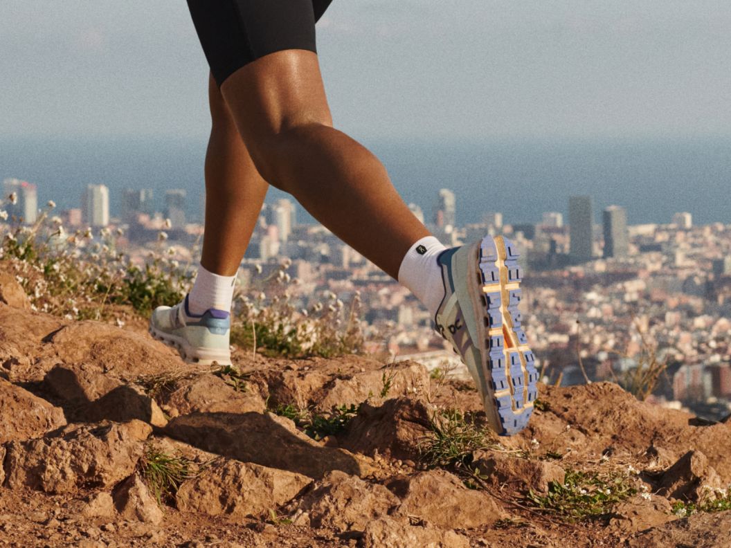 Feet running with a city in the background.